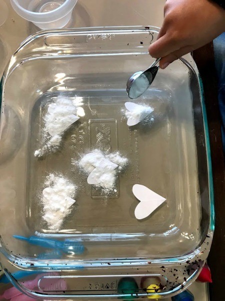 Crafting Supplies from Baking Soda and Vinegar Experiment  - adding baking soda to each paper heart shape