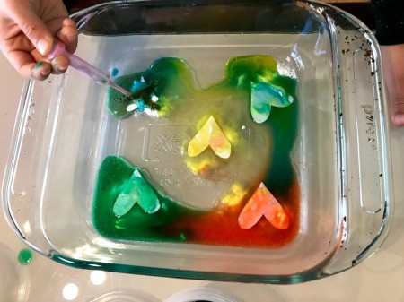 Crafting Supplies from Baking Soda and Vinegar Experiment  - adding blue dye to last soda covered heart shape