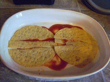 tortillas on Enchilada sauce in Casserole
