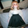 Value of an Ashley Belle Doll - doll wearing a white top with a dark flower trimmed skirt over a tan underskirt