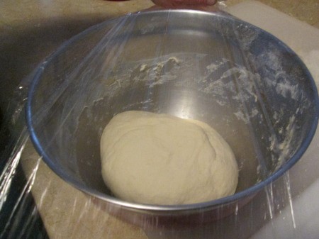 plastic covered Pizza Dough in bowl
