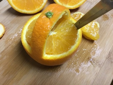 Decorative Baskets from Oranges - cut the remaining fruit out of the bottom hemisphere chop and replace in the "basket"
