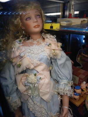 Identifying a Porcelain Doll - doll wearing a blue dress with pink trim
