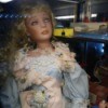 Identifying a Porcelain Doll - doll wearing a blue dress with pink trim