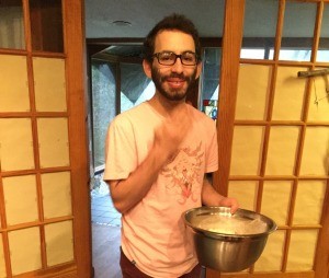 man holding bowl of popcorn