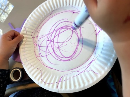 Snail Paper Plate Craft - child decorating shell (paper plate) with a marker