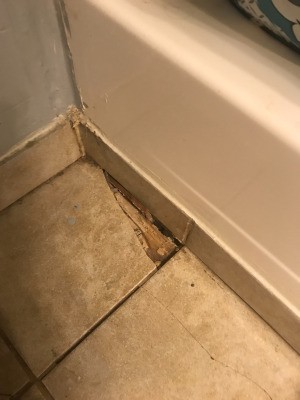 Finding Home Repair Help for Low Income Homeowners - cracked bathroom floor tile