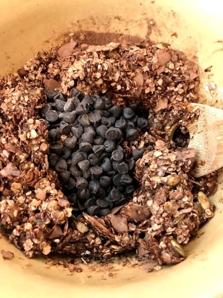 adding chocolate chips to cookie dough