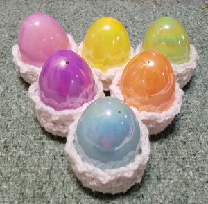 Crocheted Easter Egg Cups - 6 plastic eggs sitting in white crochet egg cups
