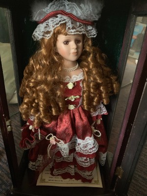 Value of an Ashley Belle Doll - doll with long ringlets wearing a maroon dress