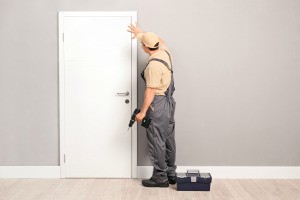 Handyman installing a door.