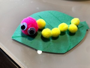 Making a Pom Pom Caterpillar - closeup of finished caterpillar on a leaf