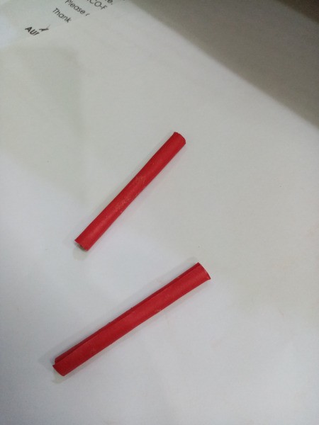 How to Make a Paper Phone Stand - roll 4 more sticks and cut in half