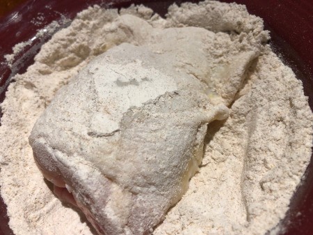 coating chicken with flour