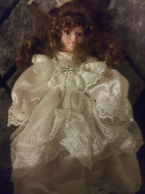Identifying a Porcelain Doll - doll wearing a satin and lace white dress