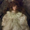 Identifying a Porcelain Doll - doll wearing a satin and lace white dress