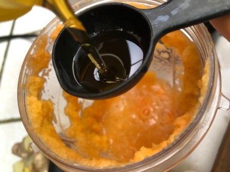 measuring oil to add to blender