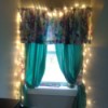 A window treatment with white Christmas "fairy" lights framing it.