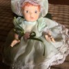 Identifying a Bisque Baby Doll - small doll wearing a mint green dress