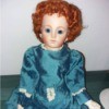 Identifying a Porcelain Doll - red haired doll wearing a old style blue dress