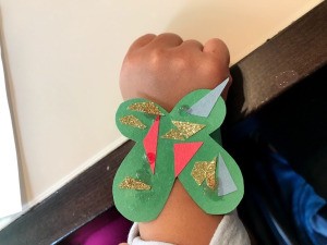 Making a Kid's Paper Butterfly Bracelet - child wearing the green butterfly
