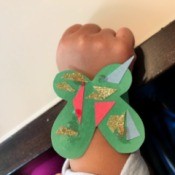 Making a Kid's Paper Butterfly Bracelet - child wearing the green butterfly