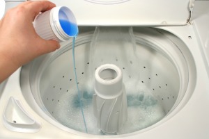 Blue liquid being poured into a dish washer.