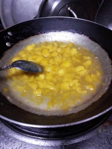 simmering mango in pan