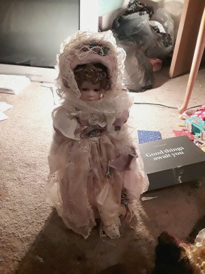 Finding the Value of Porcelain Dolls  - doll wearing a lacy pink dress