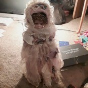 Finding the Value of Porcelain Dolls  - doll wearing a lacy pink dress