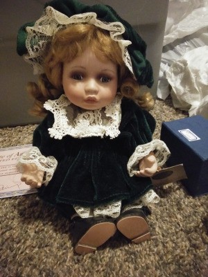 Value of a Collectible Memories Doll - small doll wearing a dark green velvet dress with lace trim