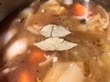 adding bay leaves to pot