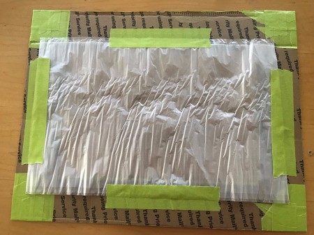 DIY Privacy Screen for Windows - tape plastic in place