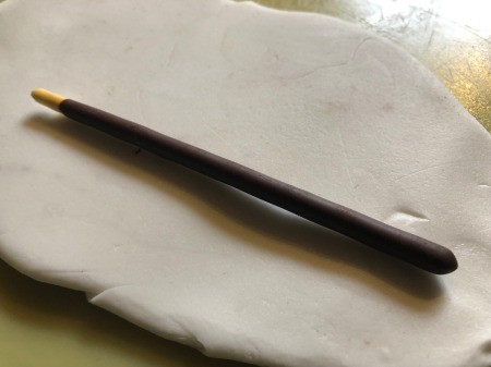 DIY Turntable Cake - to make the tonearm lay a Pocky stick on a rolled piece of fondant