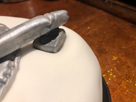 DIY Turntable Cake - place a small ball of fondant over the stick and then press the tonearm onto the ball