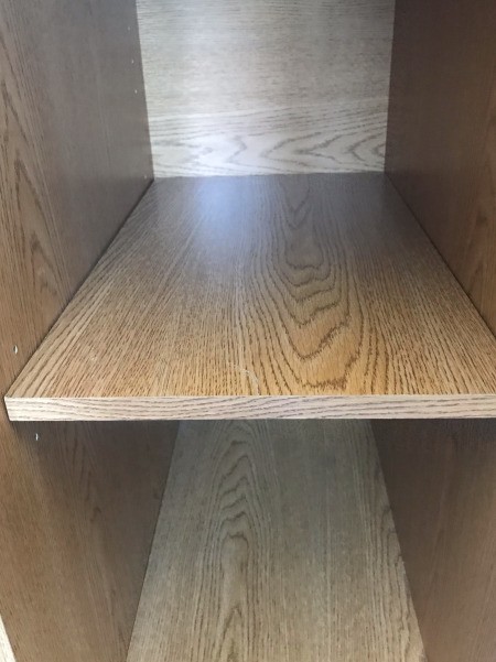 The shelf inside a repaired desk.