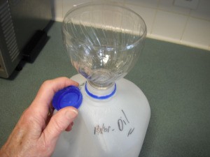 Recycling Used Motor Oil - soda bottle funnel in milk jug