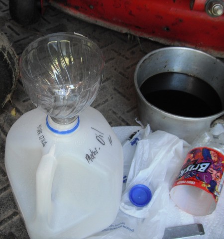 Recycling Used Motor Oil - insert into the opening in your milk jug and pour oil into the jug