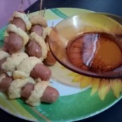 Sausage Twisters on plate with dish of maple syrup