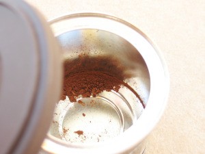 Some ground coffee left in the bottom of the coffee can.