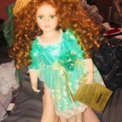 Value of a Seymour Mann Limited Edition Doll - doll wearing a straw hat and green floral dress