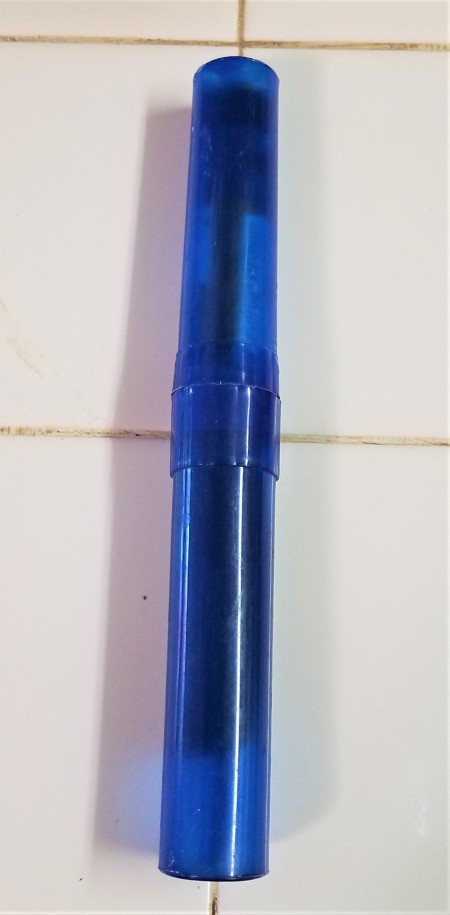 A toothbrush holder with an insulin pen stored inside.