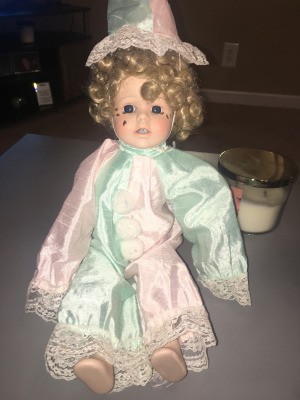 Identifying a Porcelain Doll - doll wearing a pastel pink and green outfit and hat
