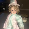 Identifying a Porcelain Doll - doll wearing a pastel pink and green outfit and hat