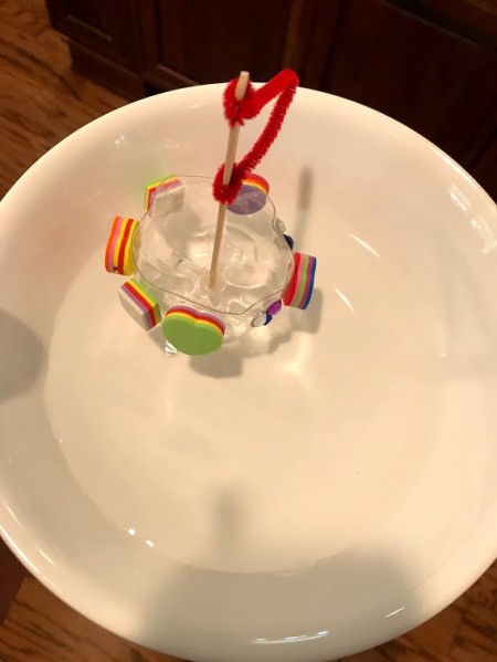 Recycled Plastic Bottle Boat - boat floating in a bowl of water, from top