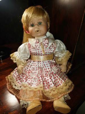 Identifying a Porcelain Doll - doll wearing a polka dot dress with lace edging and pantaloons