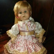 Identifying a Porcelain Doll - doll wearing a polka dot dress with lace edging and pantaloons