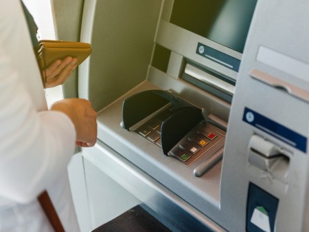A person using an ATM at a bank.