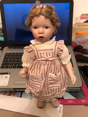 Identifying a Danbury Mint Porcelain Doll - doll with braids pinned up, wearing a striped pinafore dress