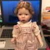Identifying a Danbury Mint Porcelain Doll - doll with braids pinned up, wearing a striped pinafore dress